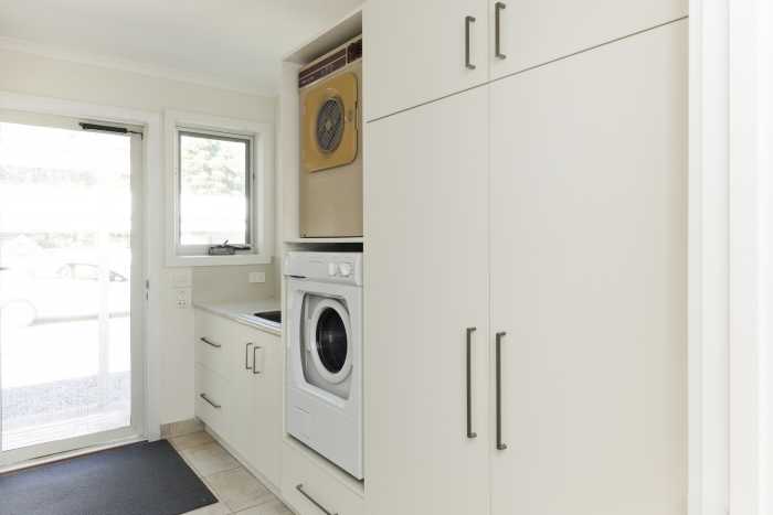 Simple Cream Laundry with Large Cupboards