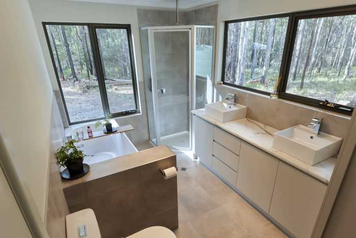 Full Bathroom with Double Vanity and Half Wall