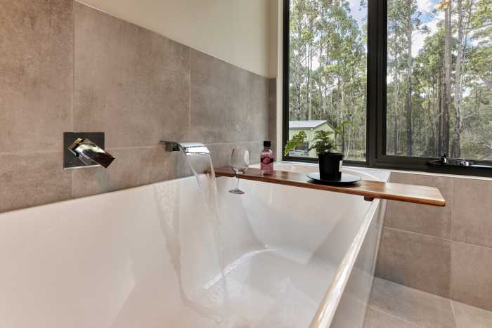 Luxurious Bathtub with Chrome Tapware and Bush Views