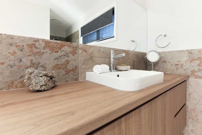 Unique Feature Tiles in Modular Bathroom with Wooden Vanity