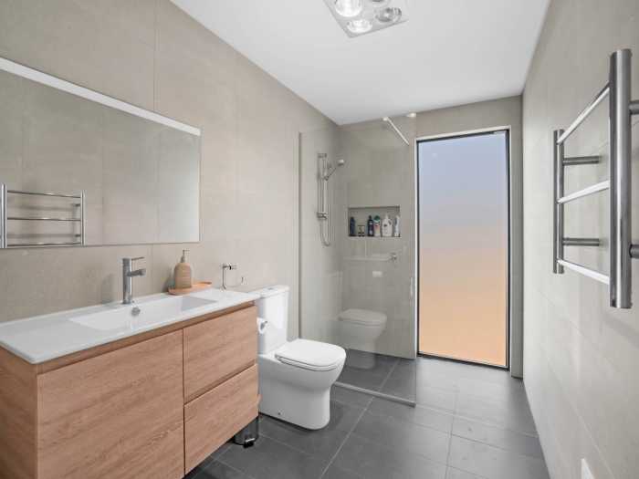 Luxury Bathroom with Open Shower and Floor Level Window