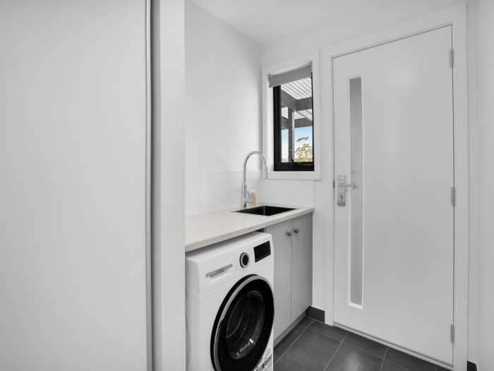 Small Laundry with Large Chrome Tap and Undermount Sink