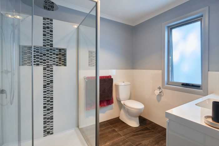 Bathroom with Tiled Niche and Blue Walls