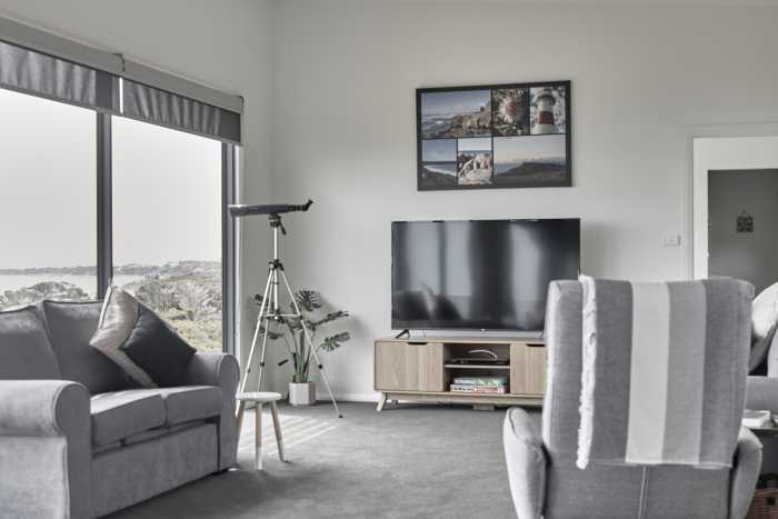 Grey Coastal Living Room with Floor Level Windows